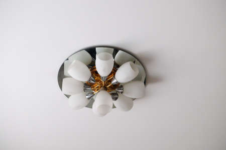 Ceiling lamp on white ceiling in homeの写真素材