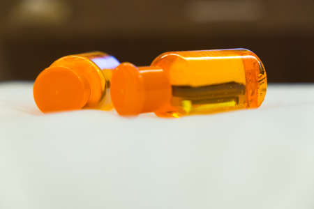 Orange shampoo, shower gel or bath foam in bottlesの写真素材