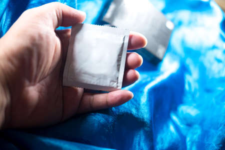 Safe sex concept. Hand with condomの写真素材