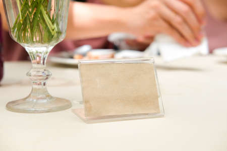 Blank frame on table in restaurant cafe shop