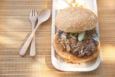 pork burger with garlic and lettuce on matの写真素材