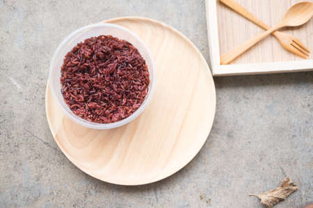 Steamed riceberry in plastic bowl on wood dishの写真素材