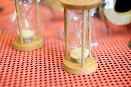 Time concept with hourglass on pink bakcgroundの写真素材