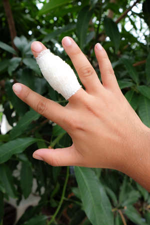 White medicine bandage on human injury hand fingerの写真素材
