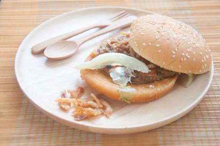 Grilled hamburger in wood plate on matの写真素材