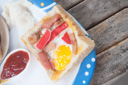 Egg in a hole is breakfast menu eat with tomato sauceの写真素材