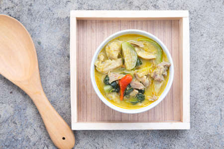 Green curry pork in wood tray , Thailand style foodの写真素材