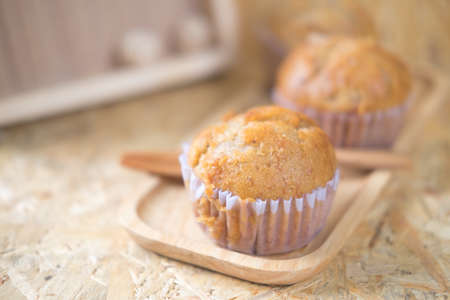 Healthy muffins made of coconut flour and banana on wood tray, selective focusの写真素材