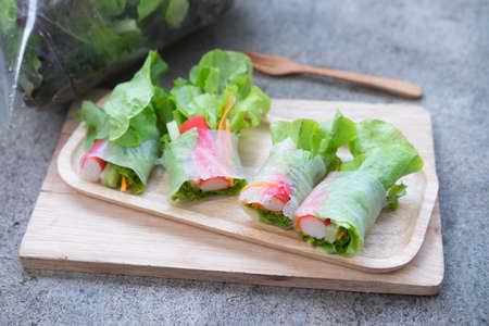 Salad roll vegetables and crab stick with salad dressingの写真素材