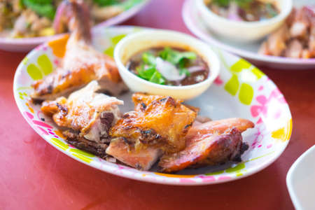 Thai style grilled chicken served with sauce, selective focusの写真素材