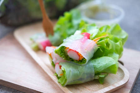 Vegetable salad roll on wood tray, healthy food. Selective focusの写真素材