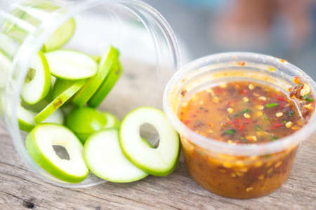 Fresh sweet and sour green sliced mango with chili paste for tropical fruit, selective focus selective focused pointの写真素材