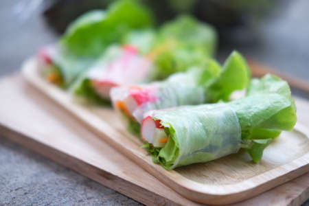 Vegetable salad roll on wood tray, healthy food. Selective focusの写真素材