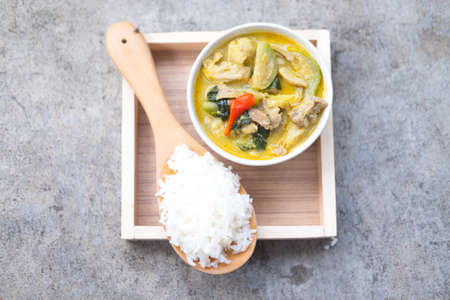 Green curry with pork eating with rice serve in wood trayの写真素材