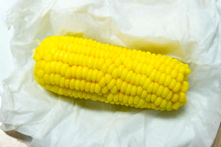 Boiled corn in a white plateの写真素材
