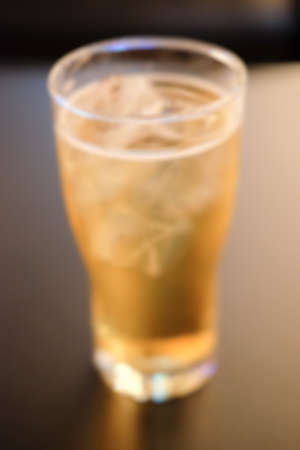 blur background, cold glass of beer on the tableの写真素材