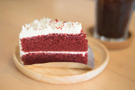 slice of strawberry layer cake on wood plate