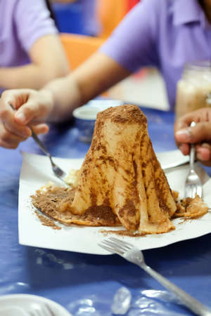sweet roti with sweetened condensed milk and cocoa powder on top, Thai style design foodの写真素材