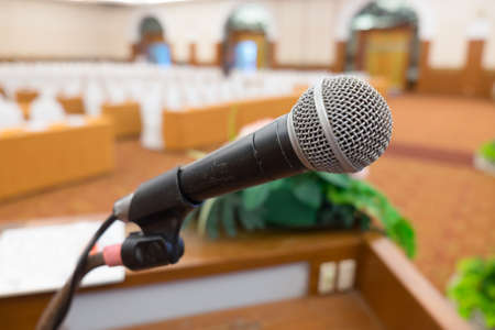 Microphone over the Abstract blurred photo of seminar room backgroundの写真素材