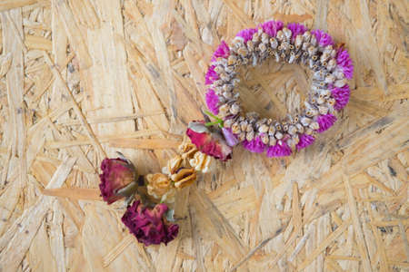 Beautiful dry garland jasmine and rose flower on wood backgroundの写真素材