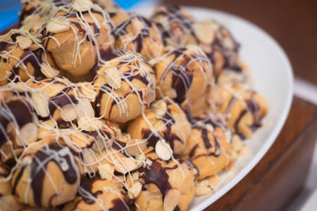 Delicious sweet baked eclairs covered with chocolate