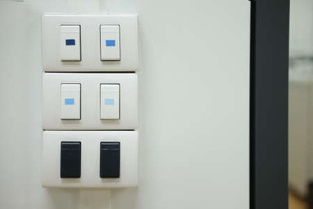Close up of light switch on white wallの写真素材