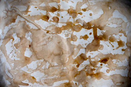 Grungy background of old stained paper with coffee cup stainsの写真素材