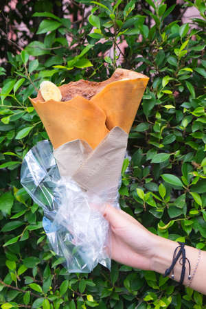 Banana chocolate crisp crepe with green leaf backgroundの写真素材