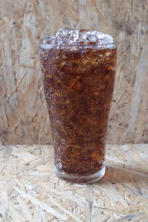 cold drink with ice on wooden table