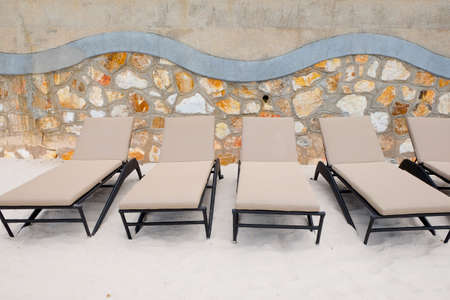Beach chairs on the sand, chaise lounge on the beach