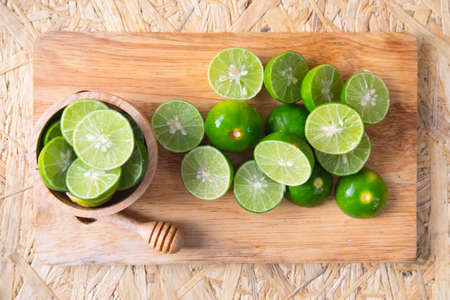 Close up of cutting lemon on chopping board for lemon juiceの写真素材