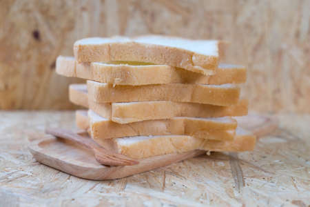 sliced bread on wood tray and wood background