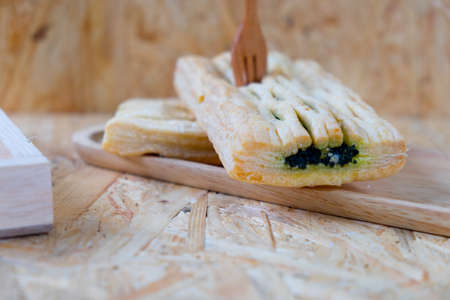 Delicious homemade spinach quiche on wood trayの写真素材