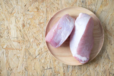 sliced raw meat on wood dish ready to cook