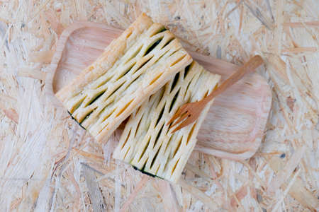 Two spinach pie on wood trayの写真素材