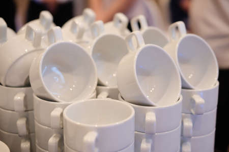 White cups for tea piled on table for coffee-breakの写真素材