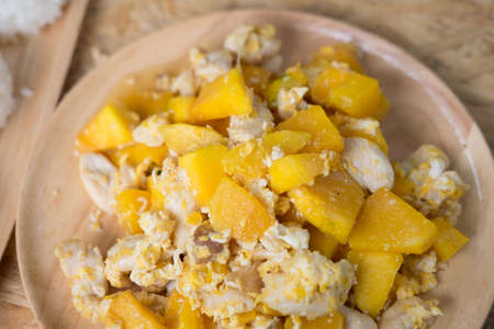 stir-fried pumpkin with pork and egg on wood dishの写真素材