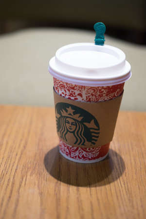 Bangkok, Thailand - December 31, 2016 : Starbucks paper cup take away have images christmas on a red cup.place on wooden tableのeditorial素材