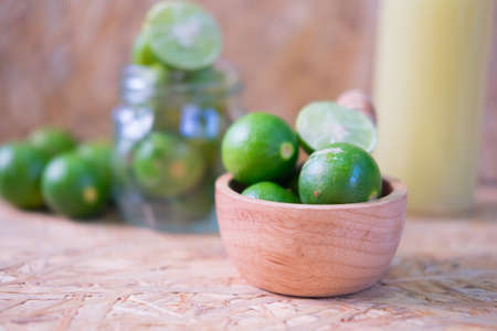 Fresh Lime and sliced lime in wood bowlの写真素材