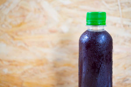 bottles with tasty drinks on wood backgroundの写真素材