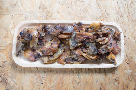 Thai style crispy fried squid on wood tray