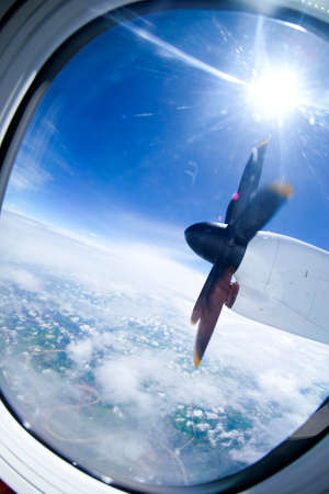 view of the propeller and clouds from a plane windowの写真素材