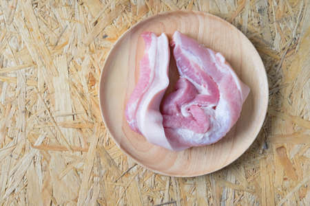 Fresh raw pork meat on wood dishの写真素材