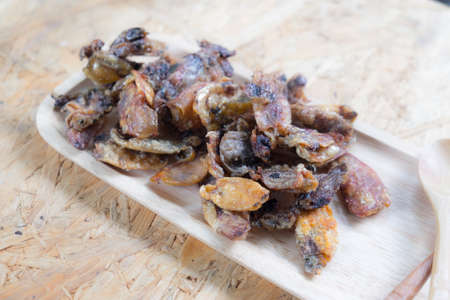 Thai style crispy fried squid on wood trayの写真素材