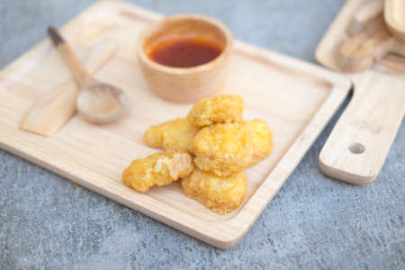 Tasty chicken nuggets on wood trayの写真素材