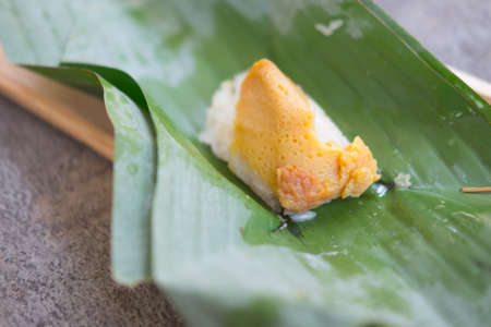 sticky rice and creamy egg custard wrapped with banana leafの写真素材