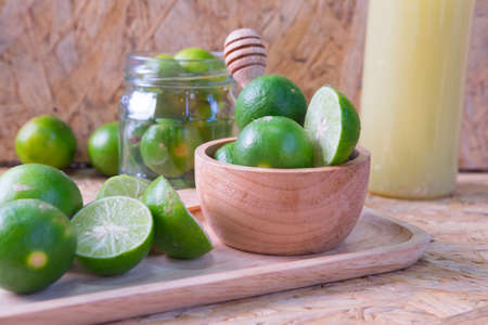 selective focus to slice fresh lime on wood bowlの写真素材