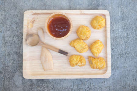 Chicken nuggets with ketchup on wooden trayの写真素材