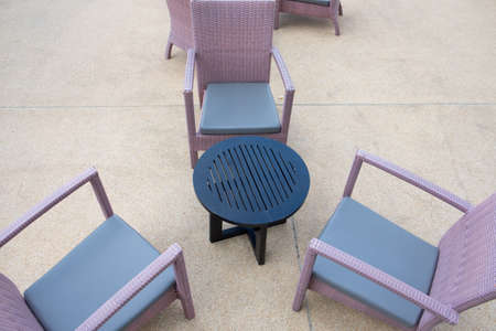 Rattan wicker chair and desk on patioの写真素材