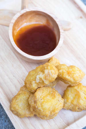 Chicken nuggets with dip ketchup on wooden trayの写真素材